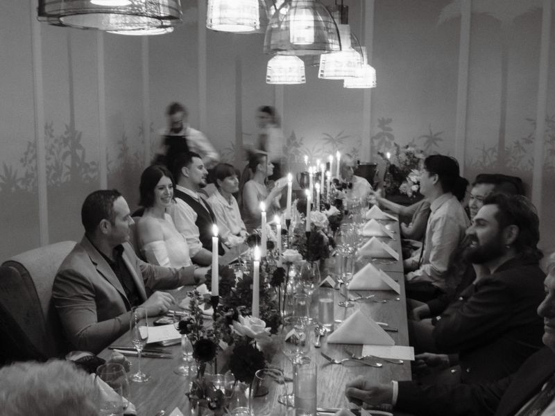 Candlelit dinner party at a long banquet table