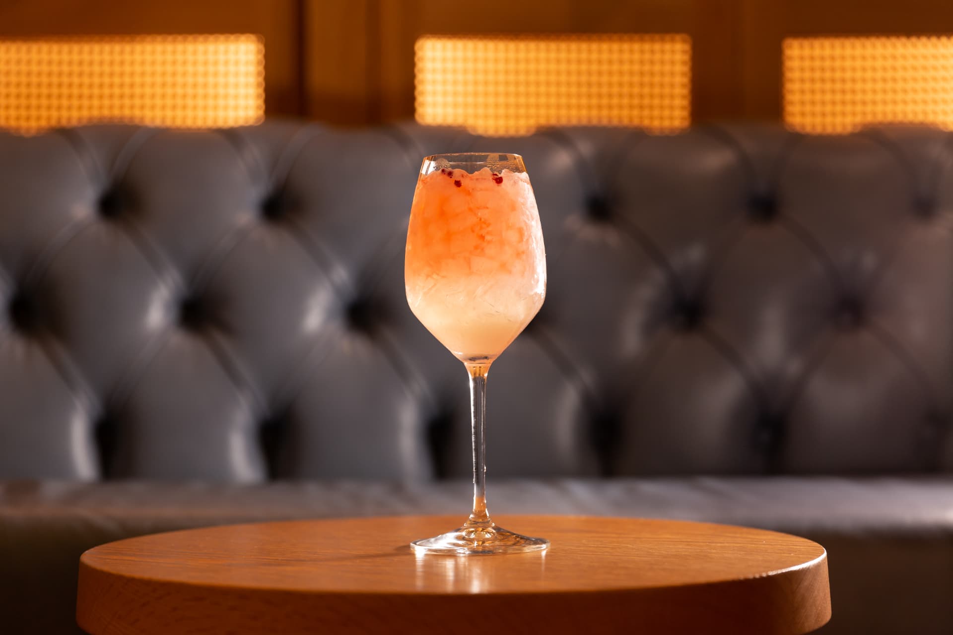 Frozen spritz in front of a tufted leather banquette