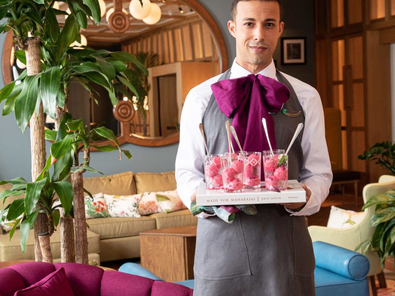 Server presenting raspberry sorbet in the lounge